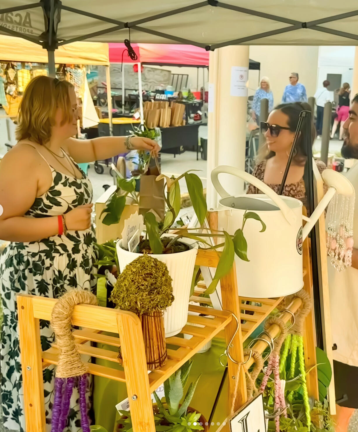 Plant sale! Marmo Market Sept 13 A young woman hosts a plant booth
