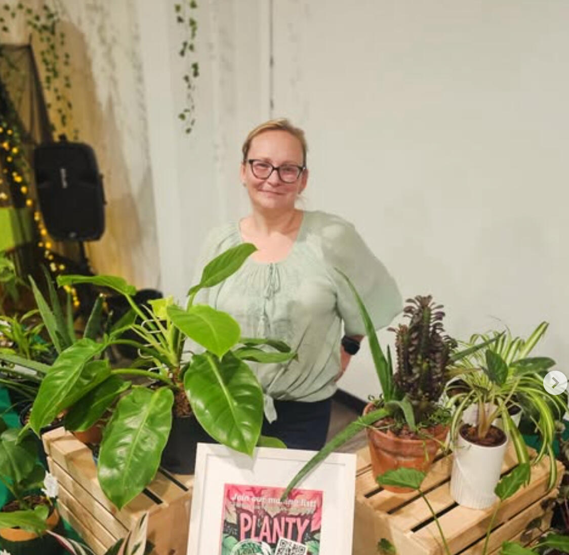 Leaf Love Studio Rox Grover, gardening enthusiast, a caucasian woman standing behind a table covered with plants