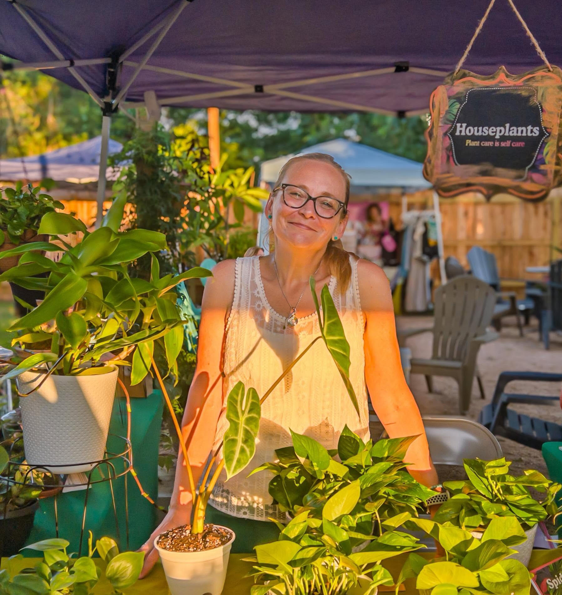 Leaf Love Studio Rox Grover, gardening enthusiast, a woman standing behind a table covered with plants at a market