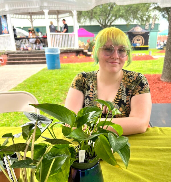 Leaf Love Studio Rox Grover, gardening enthusiast, a caucasian woman standing behind a table covered with plants